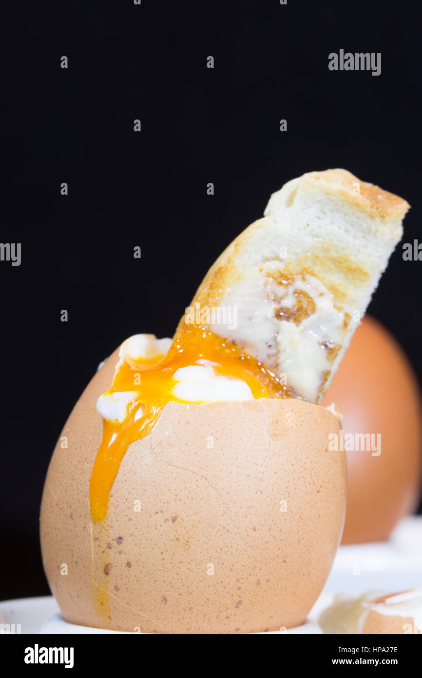 A close up of traditional British breakfast dish of soft boiled egg and toasted soldiers Stock