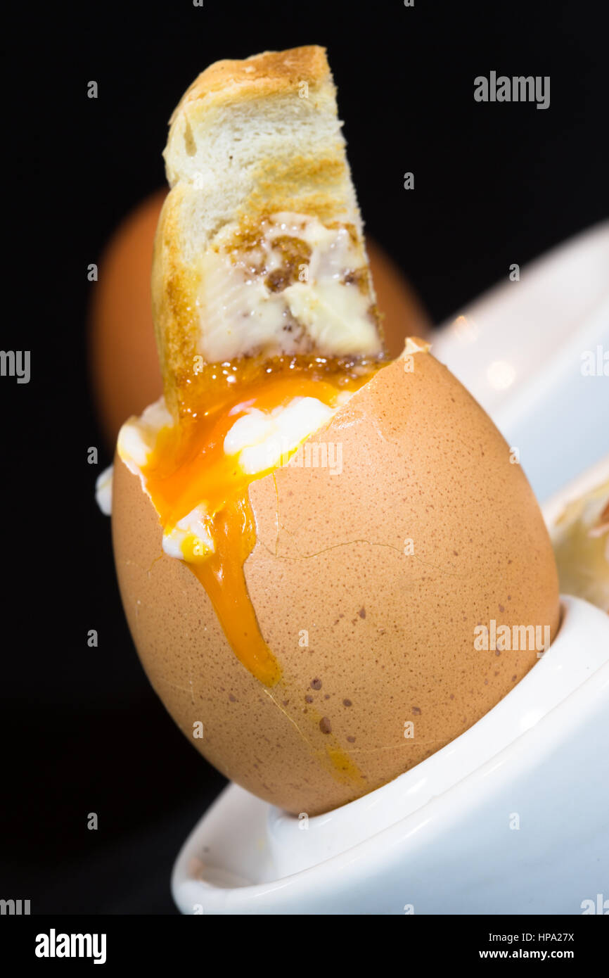 A close up of traditional British breakfast dish of soft boiled egg and