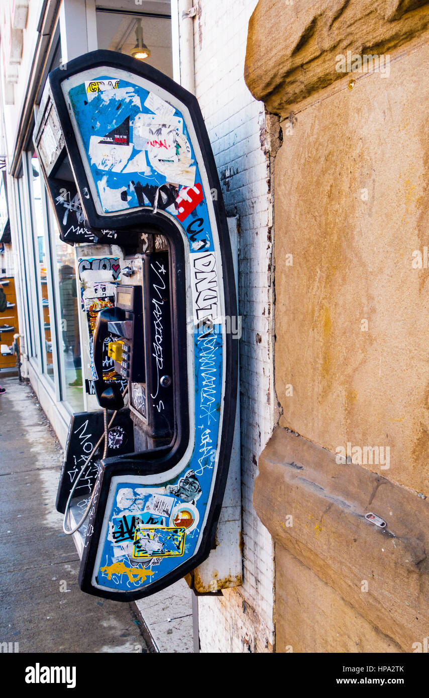 Bell Canada payphone covered in graffiti on Quees St. in Toronto, Ontario, Canada Stock Photo