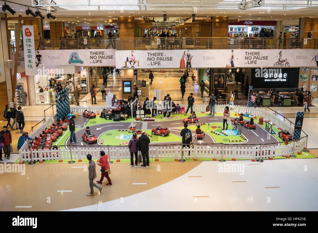 Children riding small go-karts at a shopping mall in Hong Kong Stock Photo