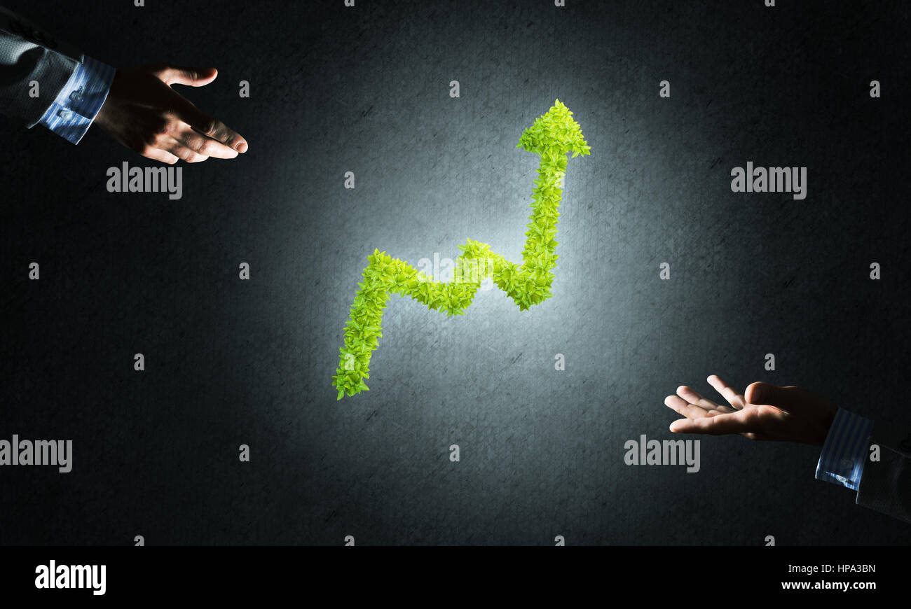 Close of businessman hand and green growing graph as symbol of progress ...