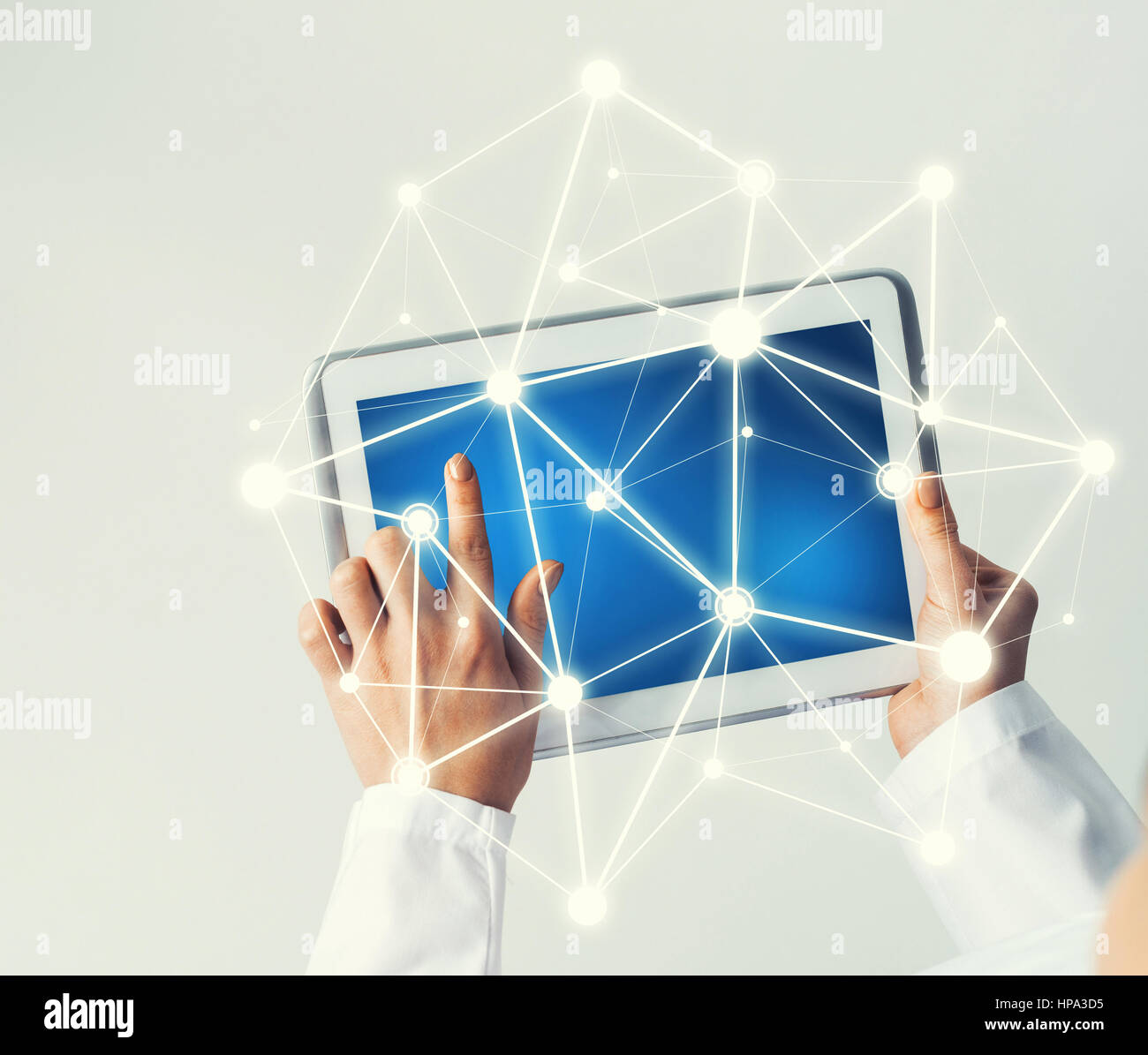 Tablet pc device with connection lines on screen in hands of doctor ...