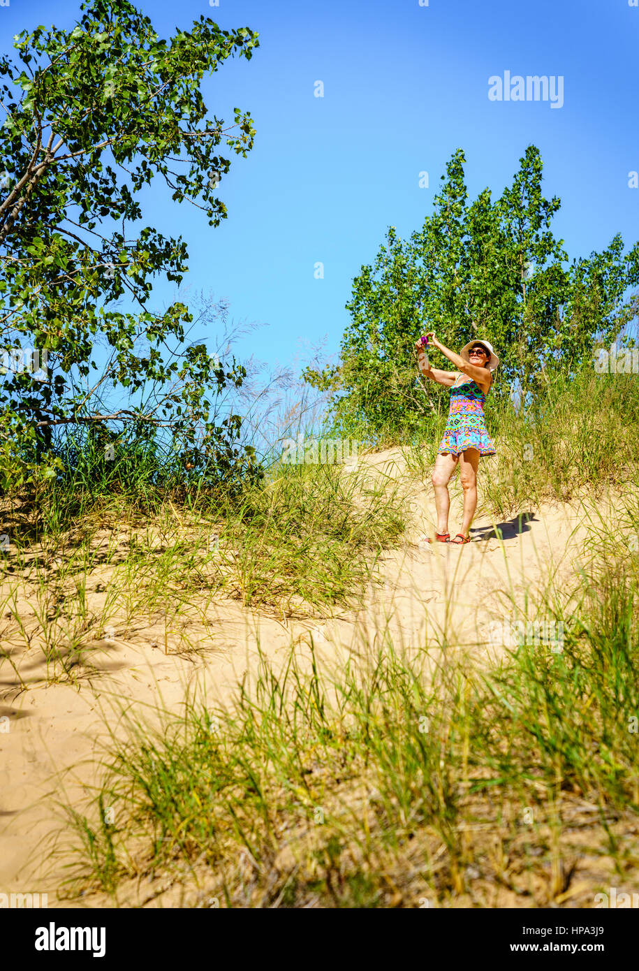 Woman is taking pictures in Sleeping Bear Dunes National Lakeshore in Northern Michigan Stock Photo