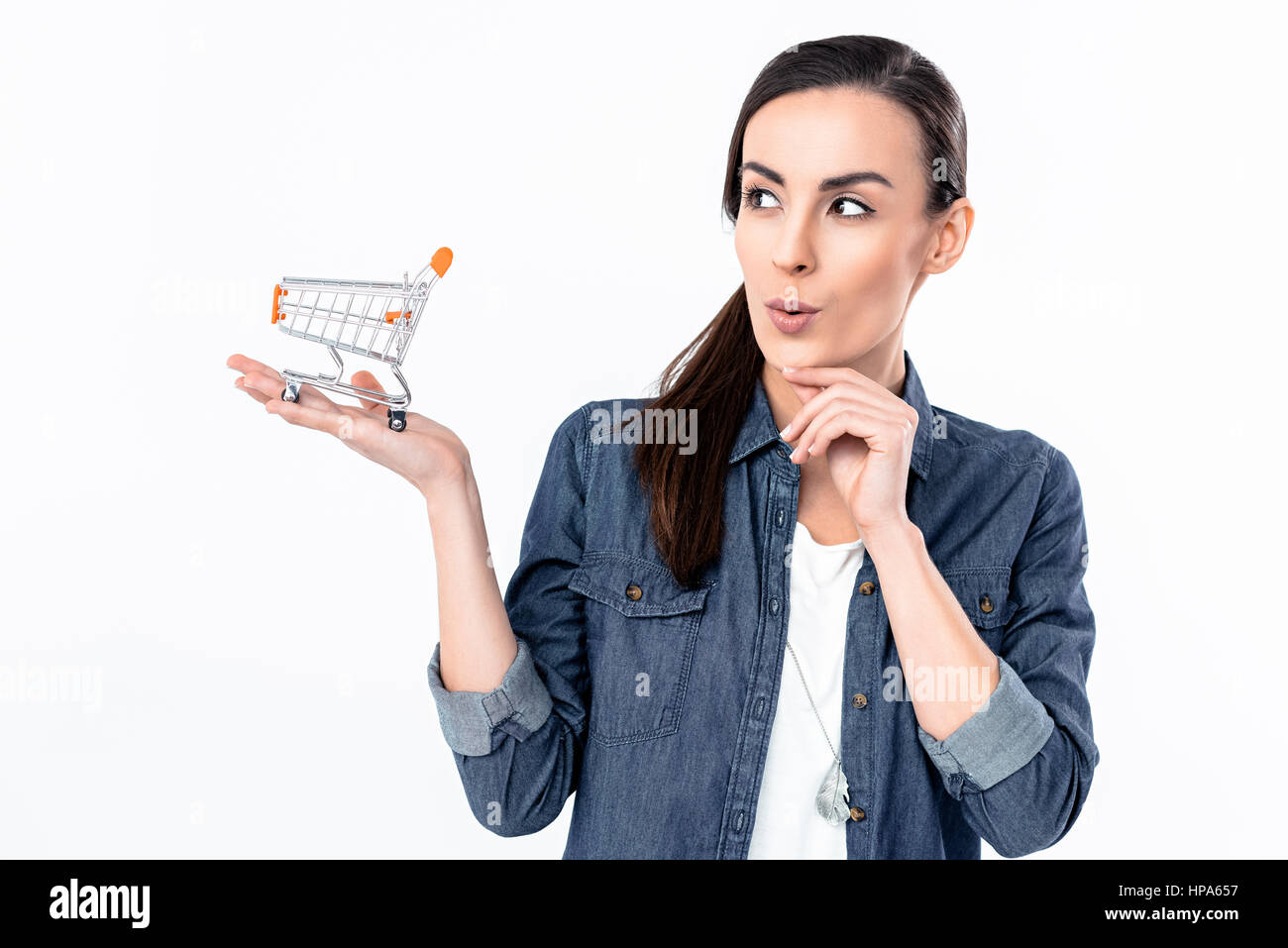 cunning woman holding shopping cart model on palm Stock Photo