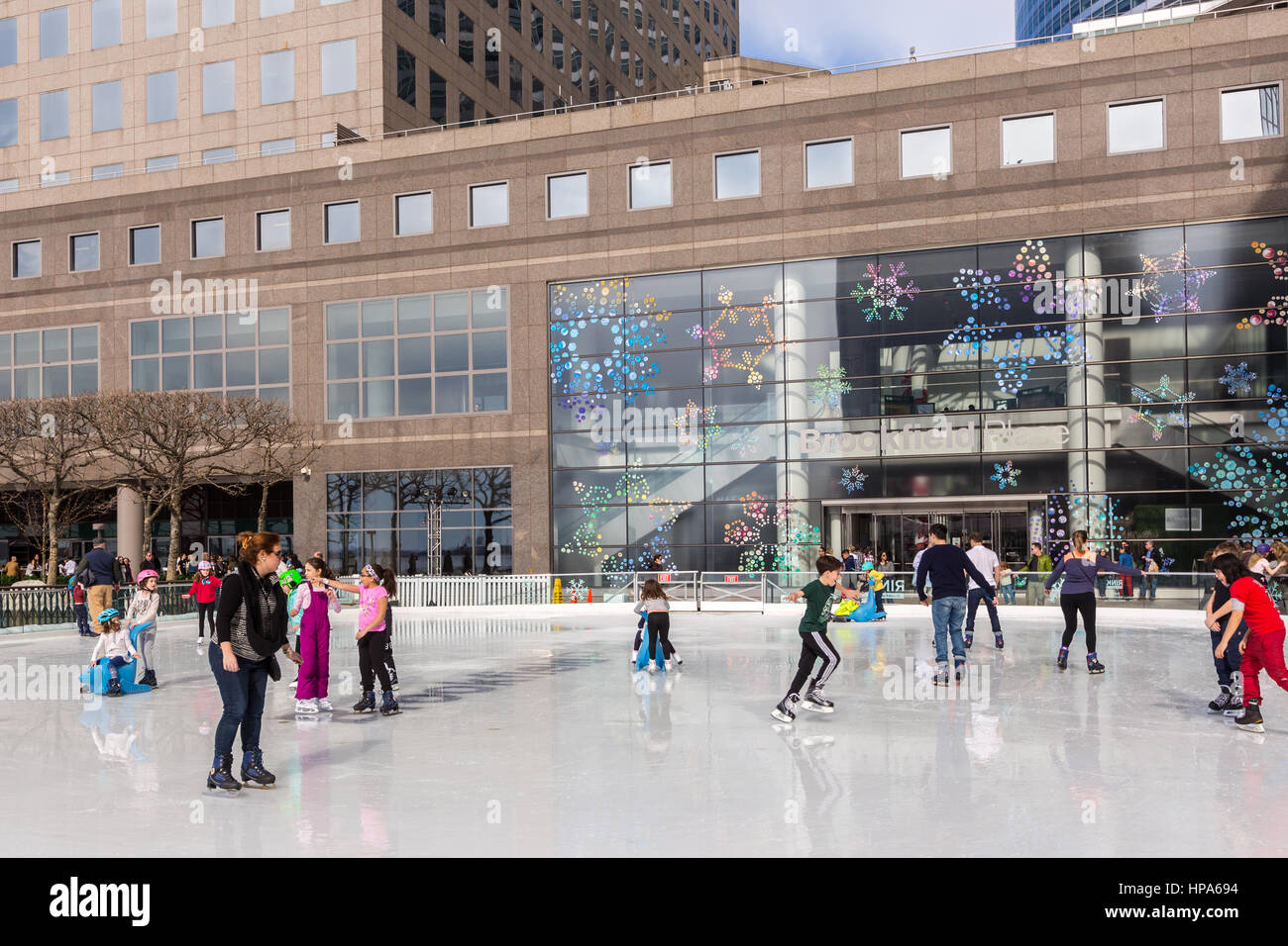 Ice skaters enjoy the Rink at Brookfield Place on a warm winter day in New York City. Stock Photo