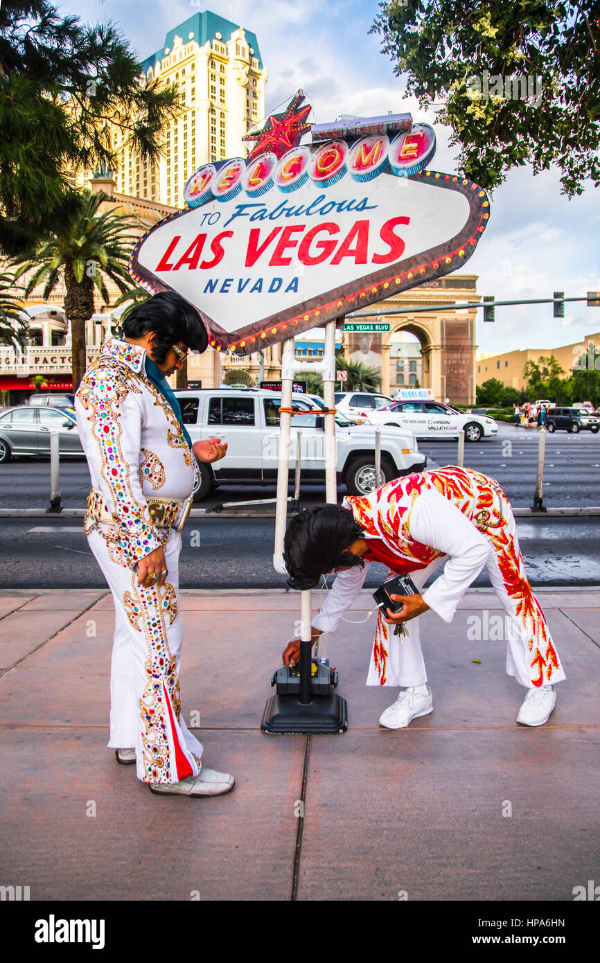 LAS VEGAS, NEVADA - MAY 7, 2014: View of Elvis impersonators performing street act along Las Vegas Boulevard. Stock Photo