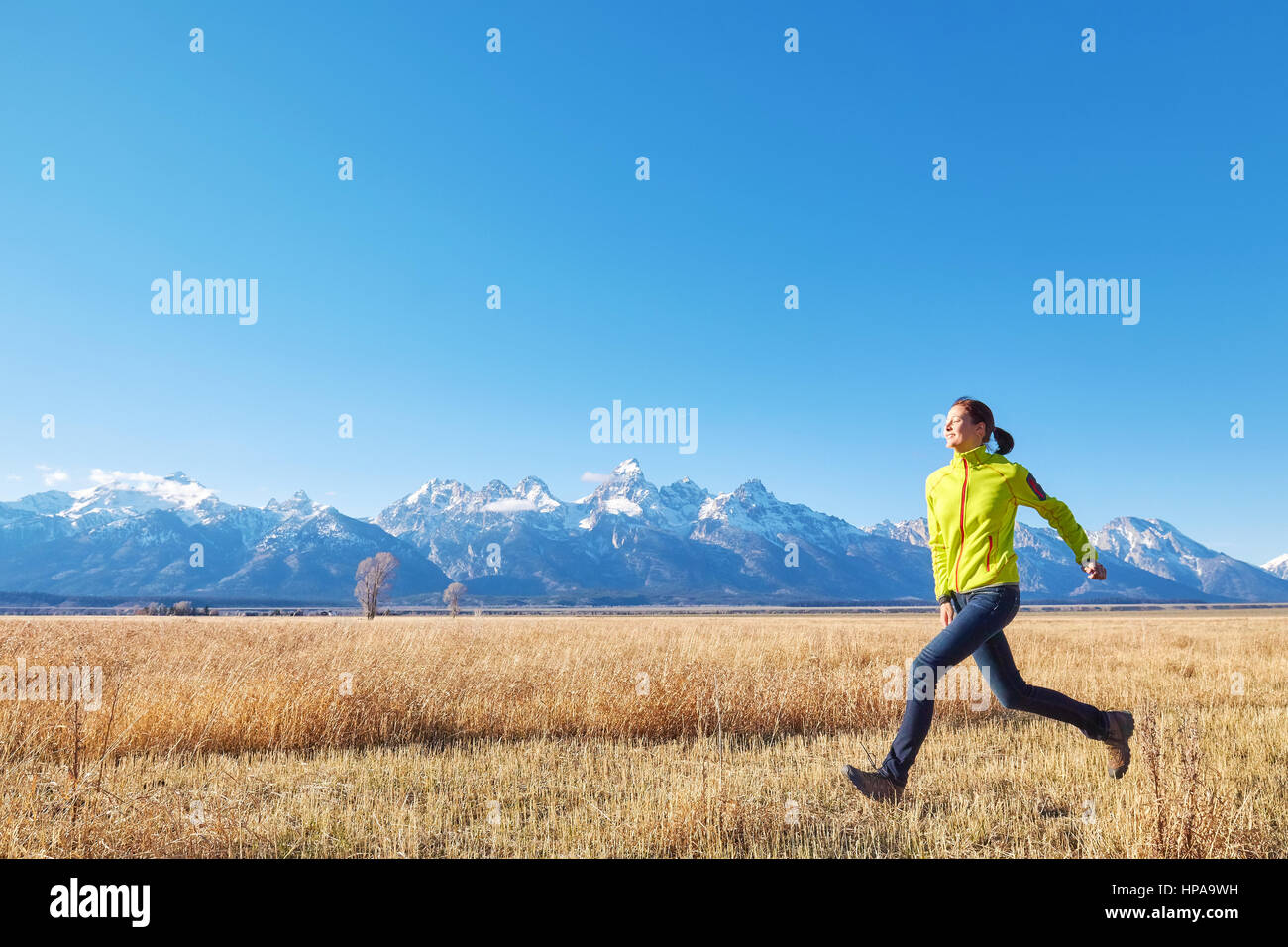 Happy Woman Enjoying Life In Field At Sunset In Mountains Stock Photo,  Picture and Royalty Free Image. Image 119496928.