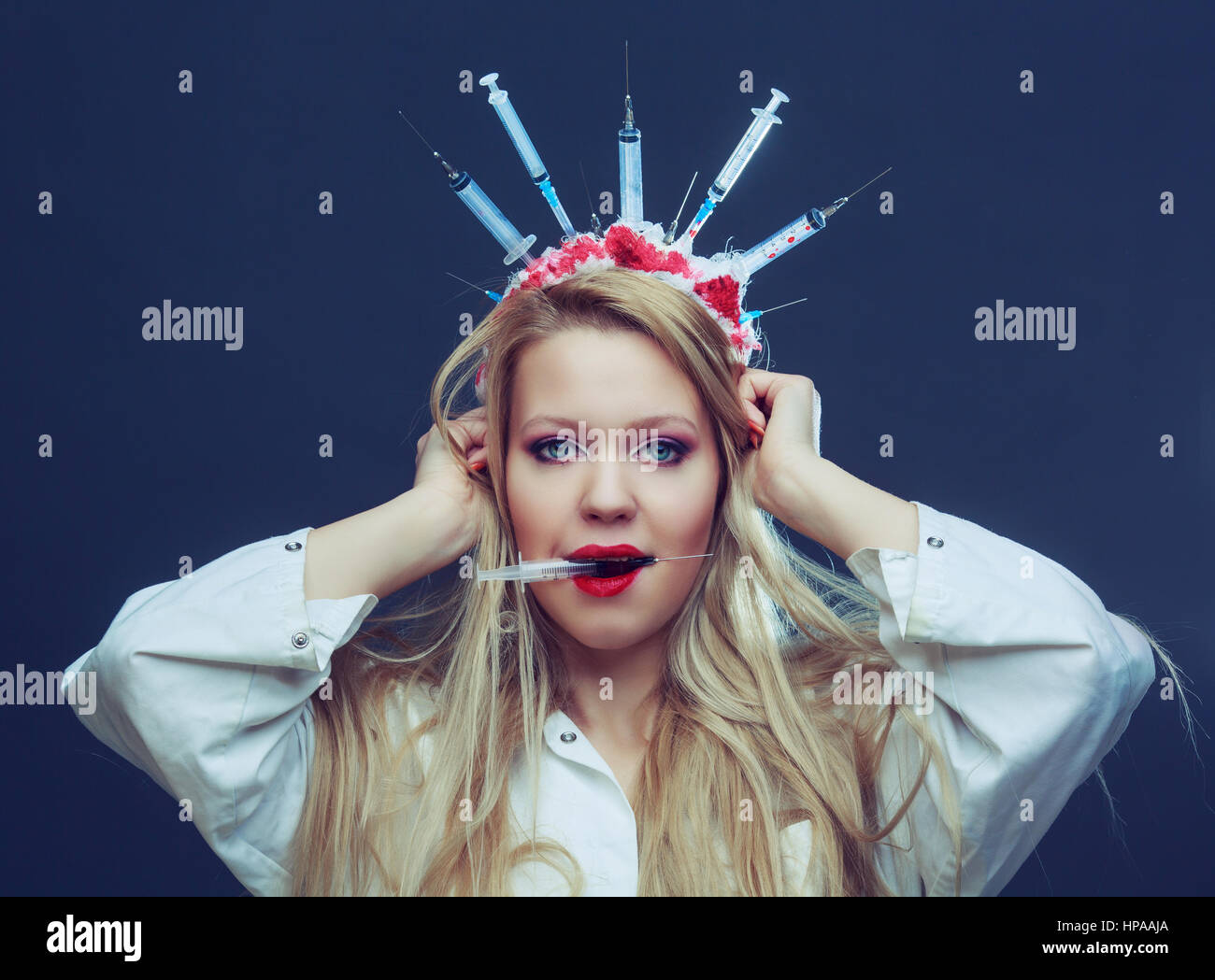 Halloween costume of a crazy nurse with crown made of syringes and a