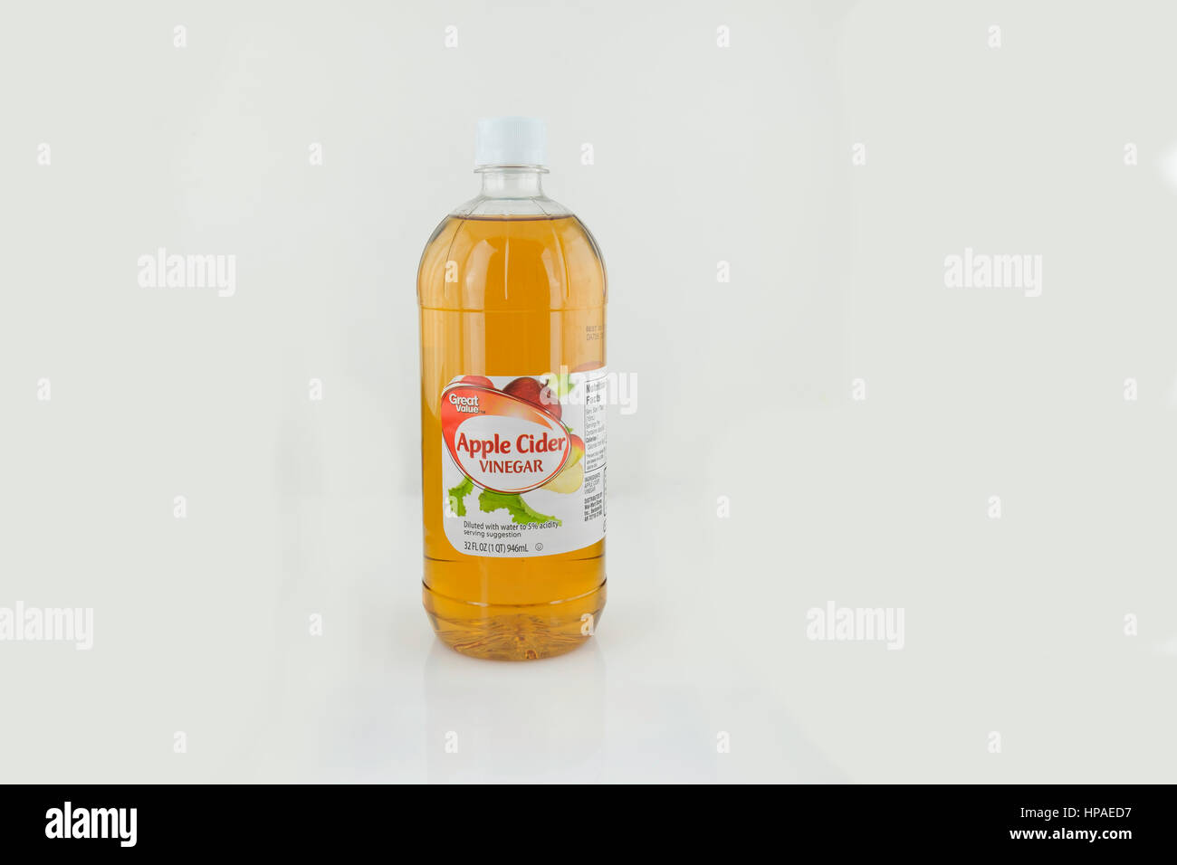 A bottle of store brand apple cider vinegar, cutout,white background. USA. Stock Photo