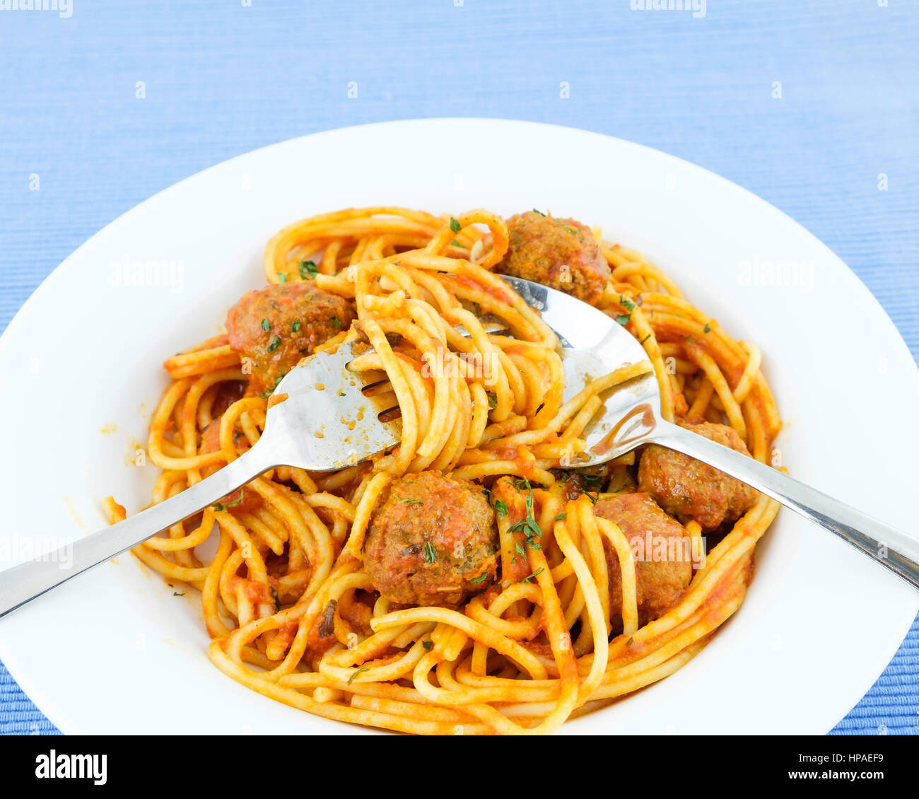 A plate of home cooked savory spaghetti and meatballs with eating