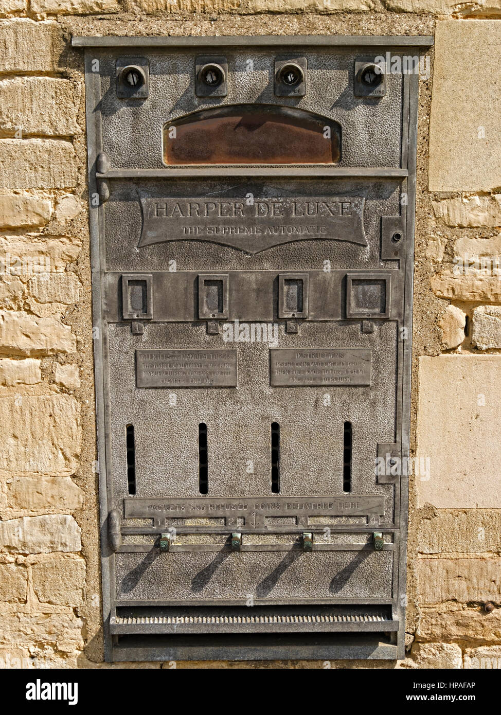 Old Harper De Luxe, wall mounted automatic cigarette vending slot machine, St. Martins, Stamford, Lincolnshire, England, UK Stock Photo