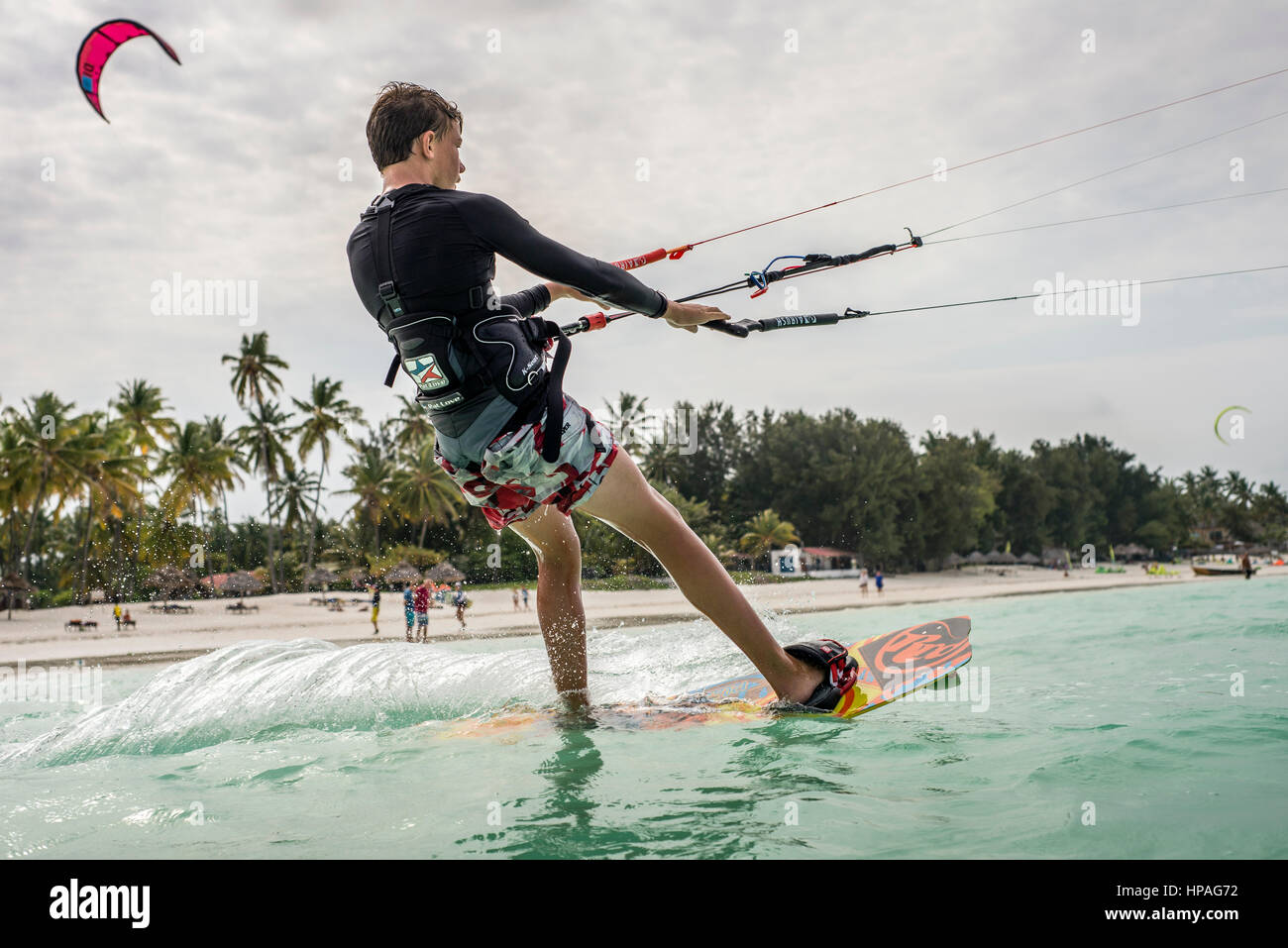 A boy flying kite on a beach of Paje, Zanzibar, Tanzania. Paje is a