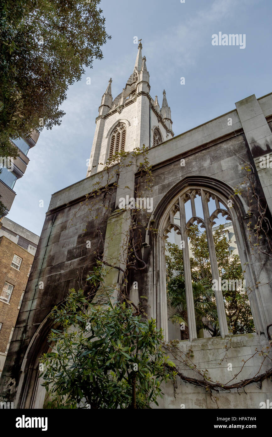 The war torn shell of a histroic church in London, with a Christopher Wren designed spire now houses a tranquil garden for all to enjoy. Stock Photo