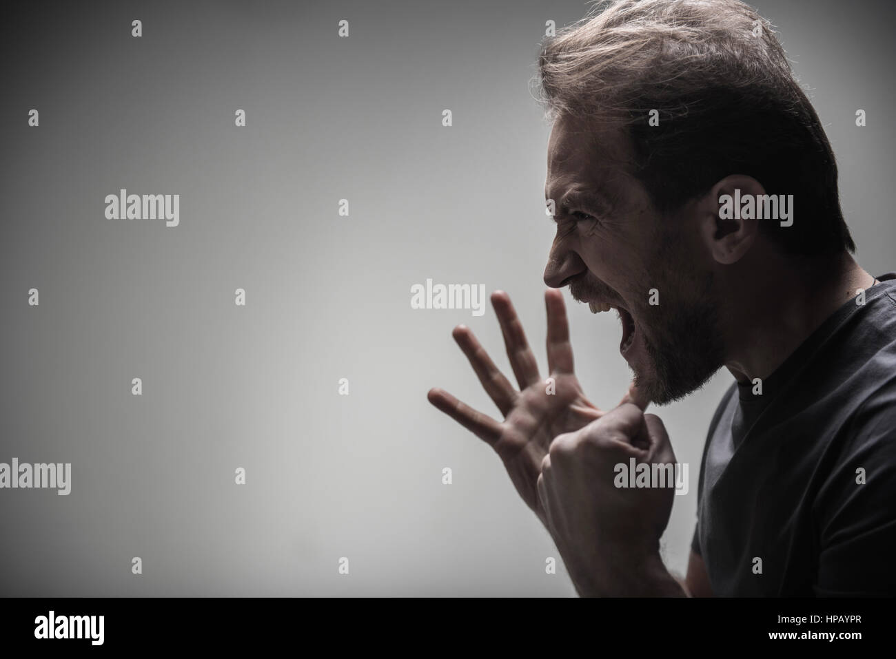 My passion. Angry male person opening his mouth while showing his fist ...