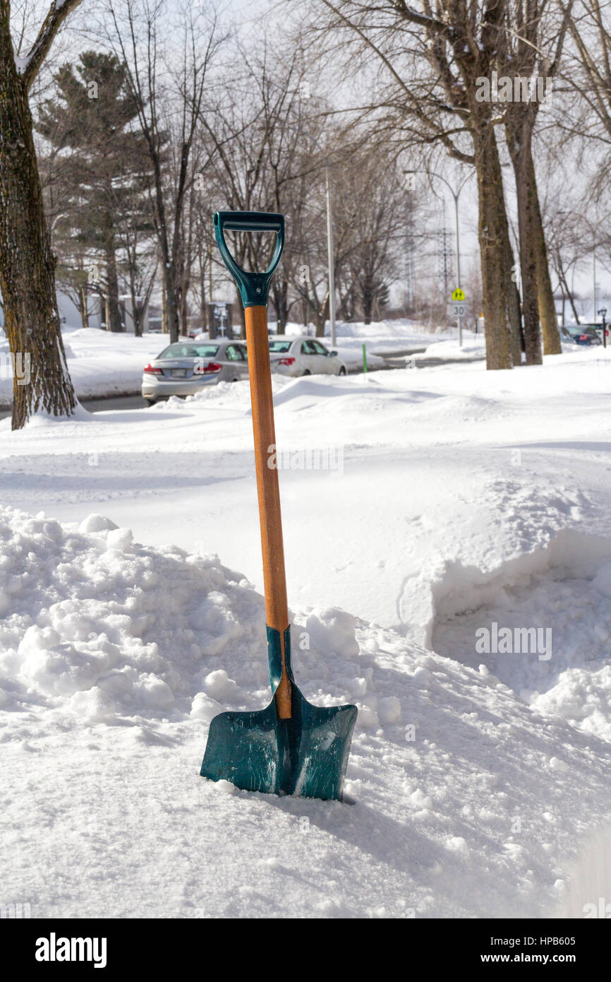 view of a winter shovel on the frontyard of a residential street of Sorel-Tracy in Quebec Canada Stock Photo