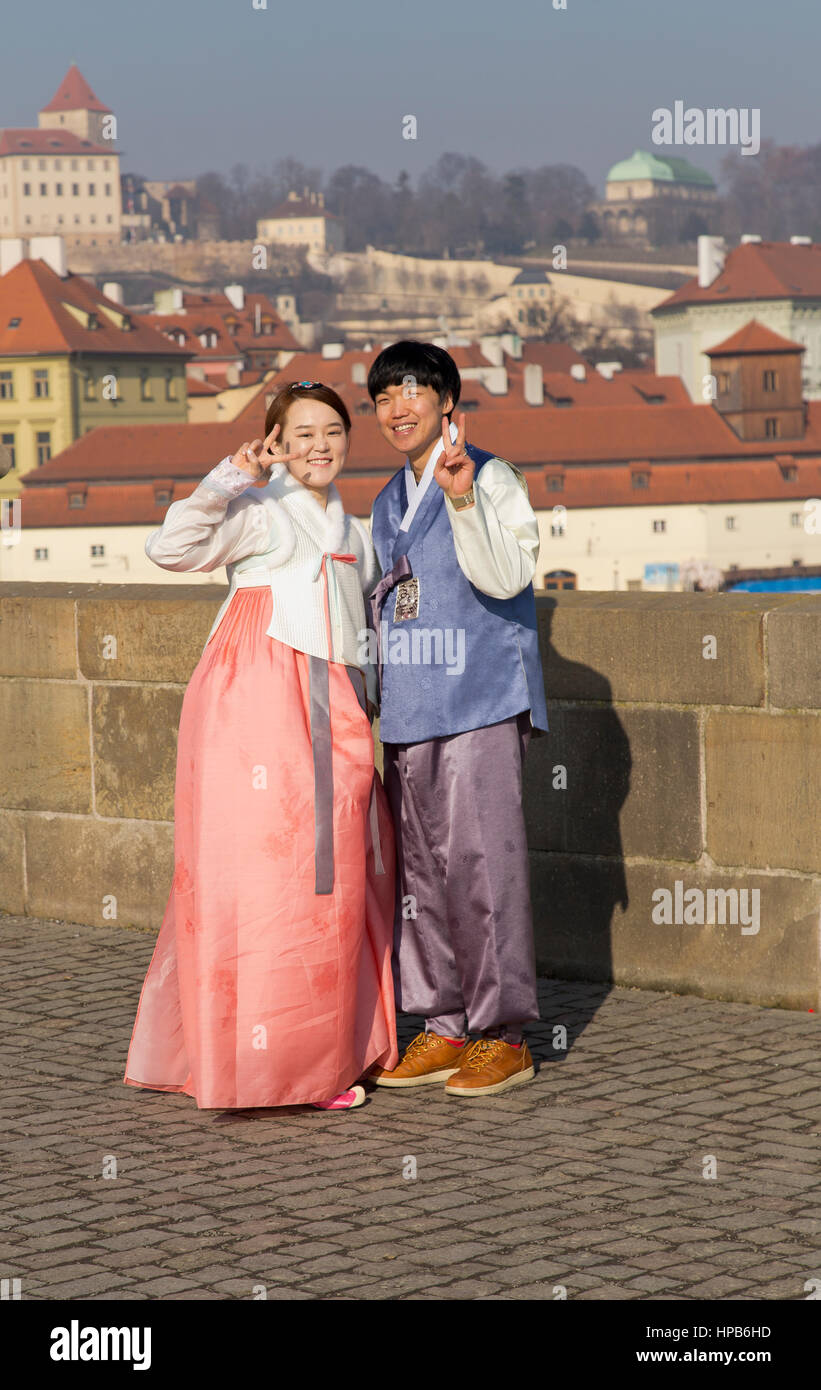 South Korean couple in traditional dress on Charles Bridge in Prague Czech Republic Stock Photo