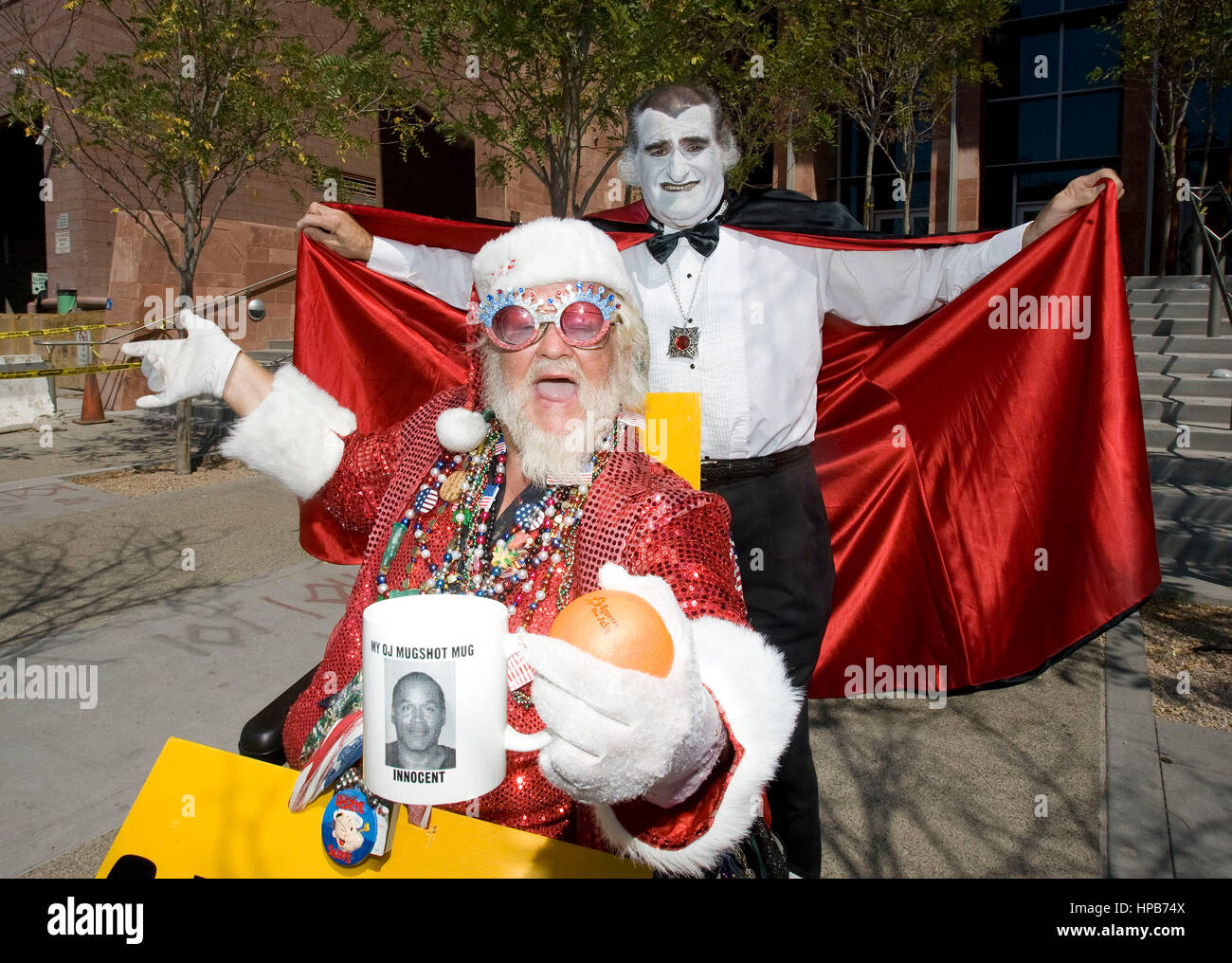 Bill Wandland of Las Vegas, left, holds his O.J. Simpson mug, and Joe Pepitone of Brooklyn, dresses up as Grandpa Munster in front of the Clark County Regional Justice building, the site of the O.J. Simpson trial in Las Vegas, NV on Monday,  Sept. 15, 2008. Photo credit: Francis Specker Stock Photo