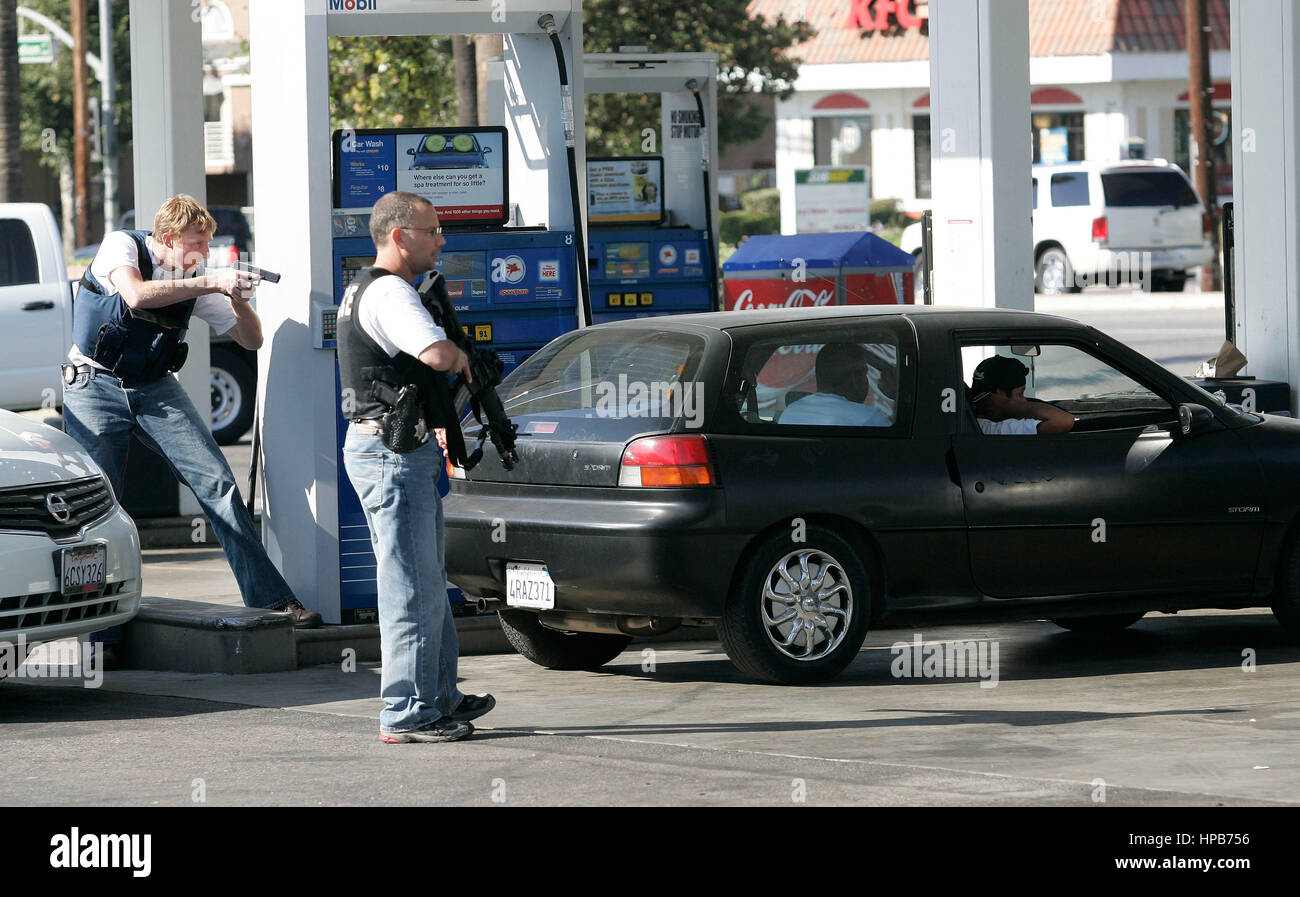 FBI agents arrest a group of men at the Mobil gas station on Madison Street in Riverside