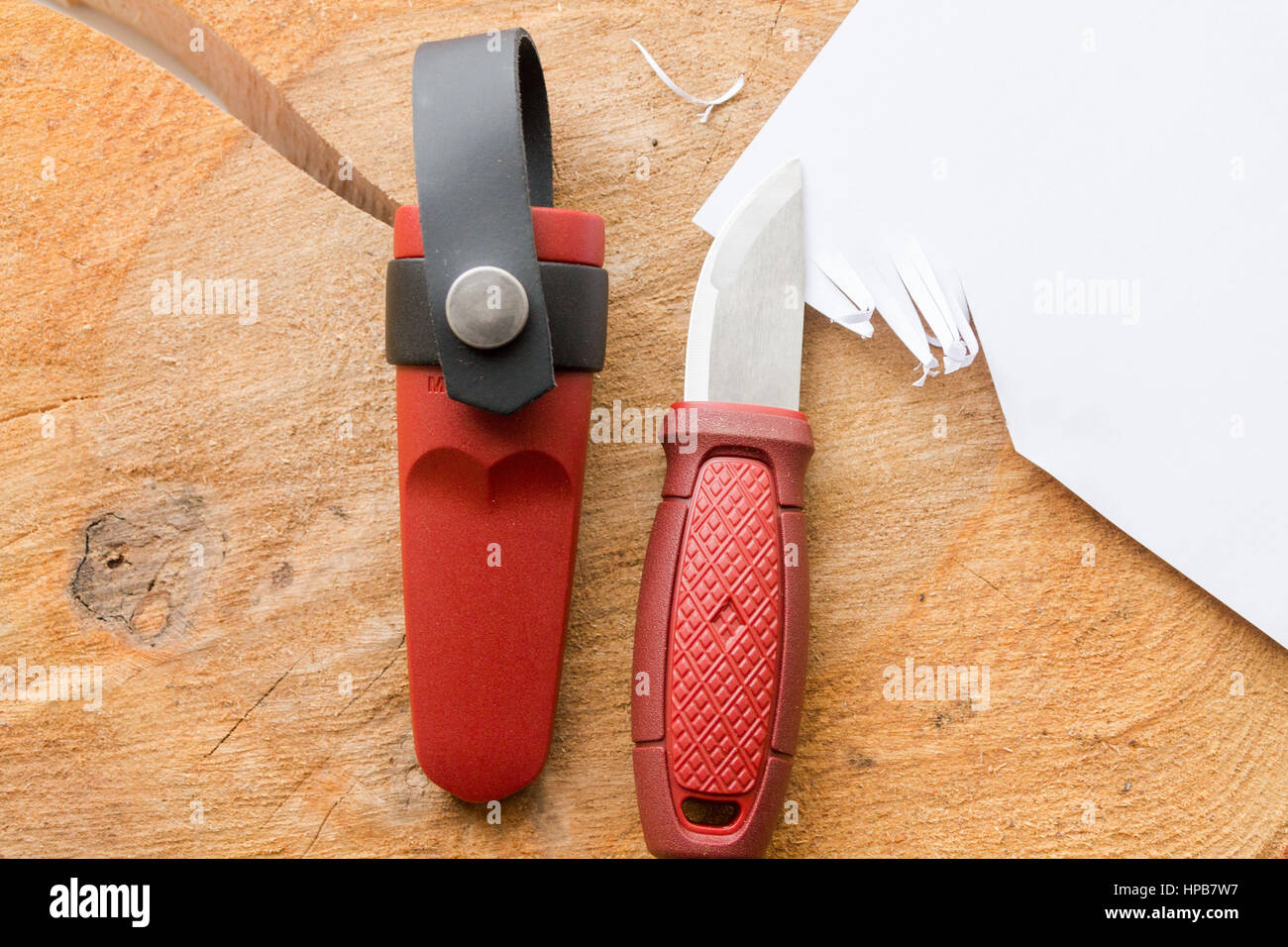 Sliced paper with a sharp knife. A small knife with casw Stock Photo