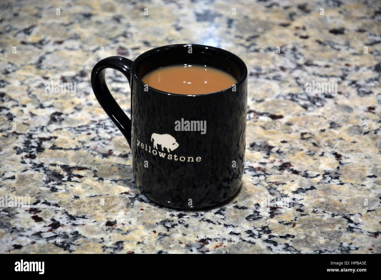 Cup of coffee on the kitchen counter in a Yellowstone logo mug Stock
