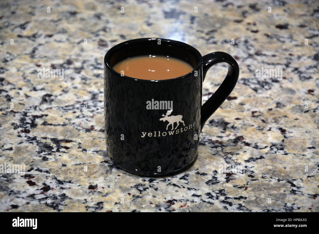 Cup of coffee on the kitchen counter in a Yellowstone logo mug Stock