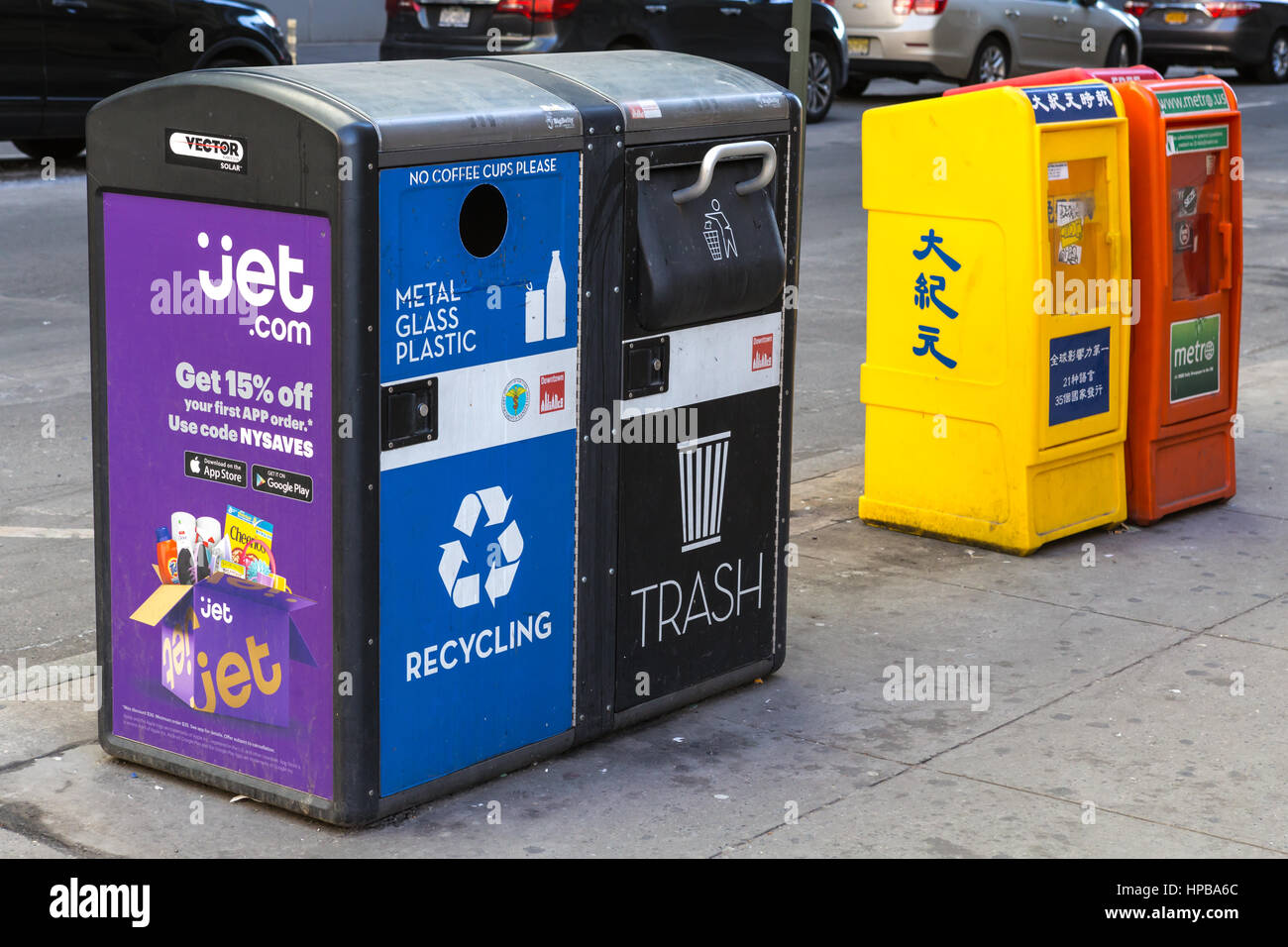 Solar-powered smart recycling and trash compactors deployed on a street in New York City. Stock Photo