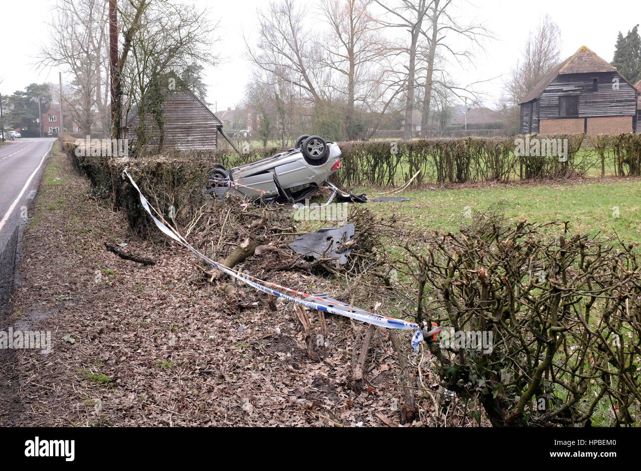 Overturned car landed upside down with police tape in Charlwood near