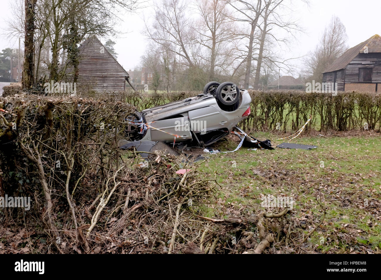 Overturned car landed upside down with police tape in Charlwood near