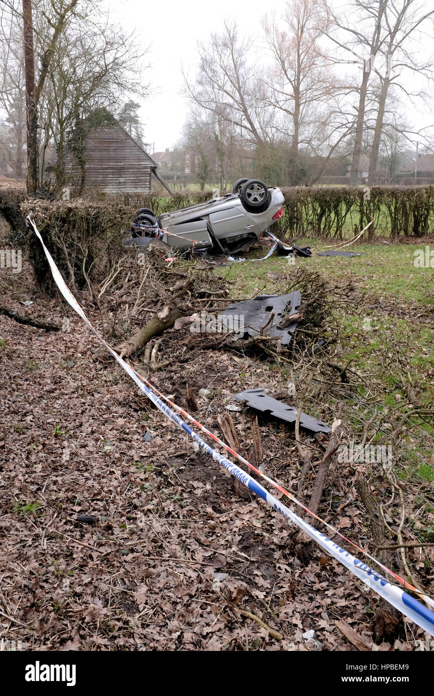 Overturned car landed upside down with police tape in Charlwood near