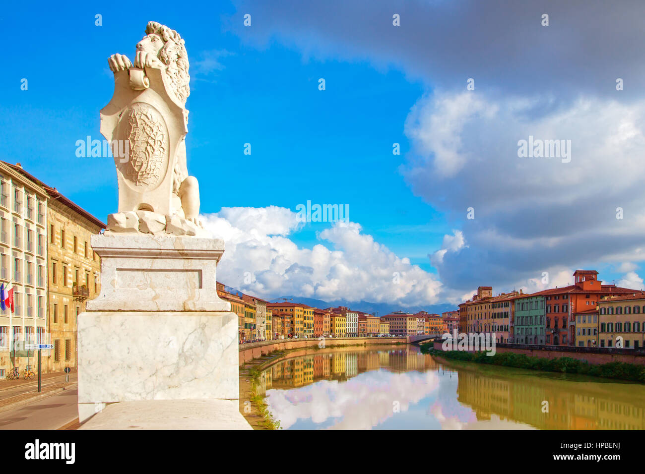Pisa, Arno river, lion statue and building facades reflection. Lungarno view. Tuscany, Italy, Europe. Stock Photo