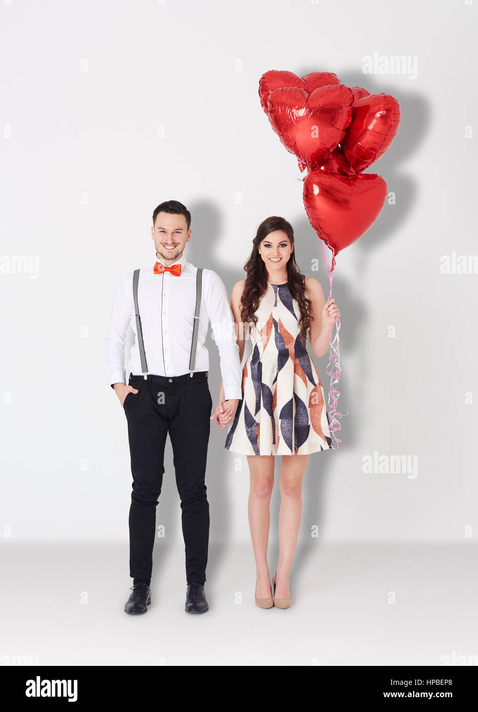 Loving couple with some red balloons Stock Photo - Alamy