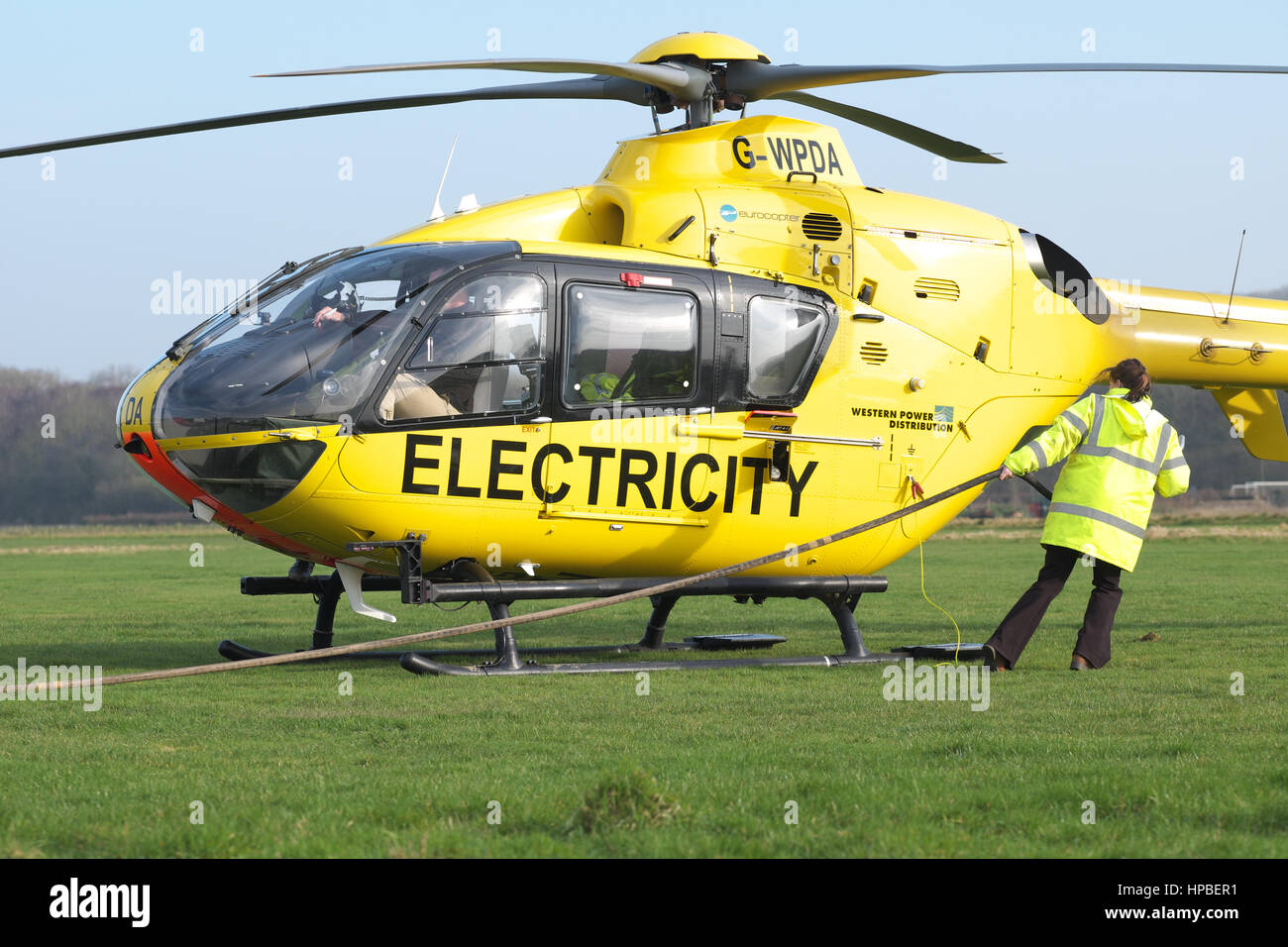 Eurocopter EC 135 helicopter used for electricity power supply  checking by Western Power Distribution WPD in UK being refueled Stock Photo