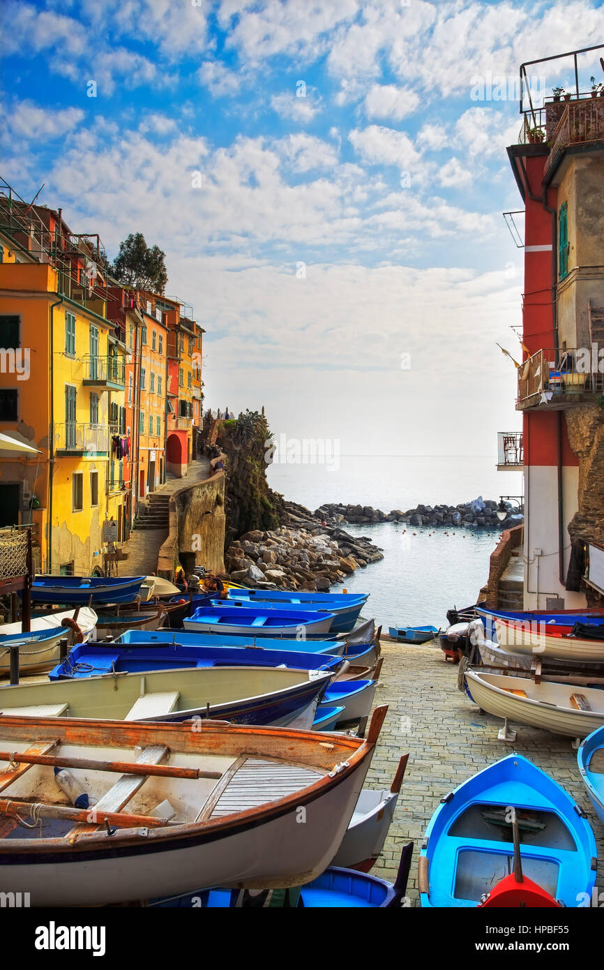 Riomaggiore village street, boats and sea in Five lands, Cinque Terre National Park, Liguria Italy Europe. long exposure Stock Photo