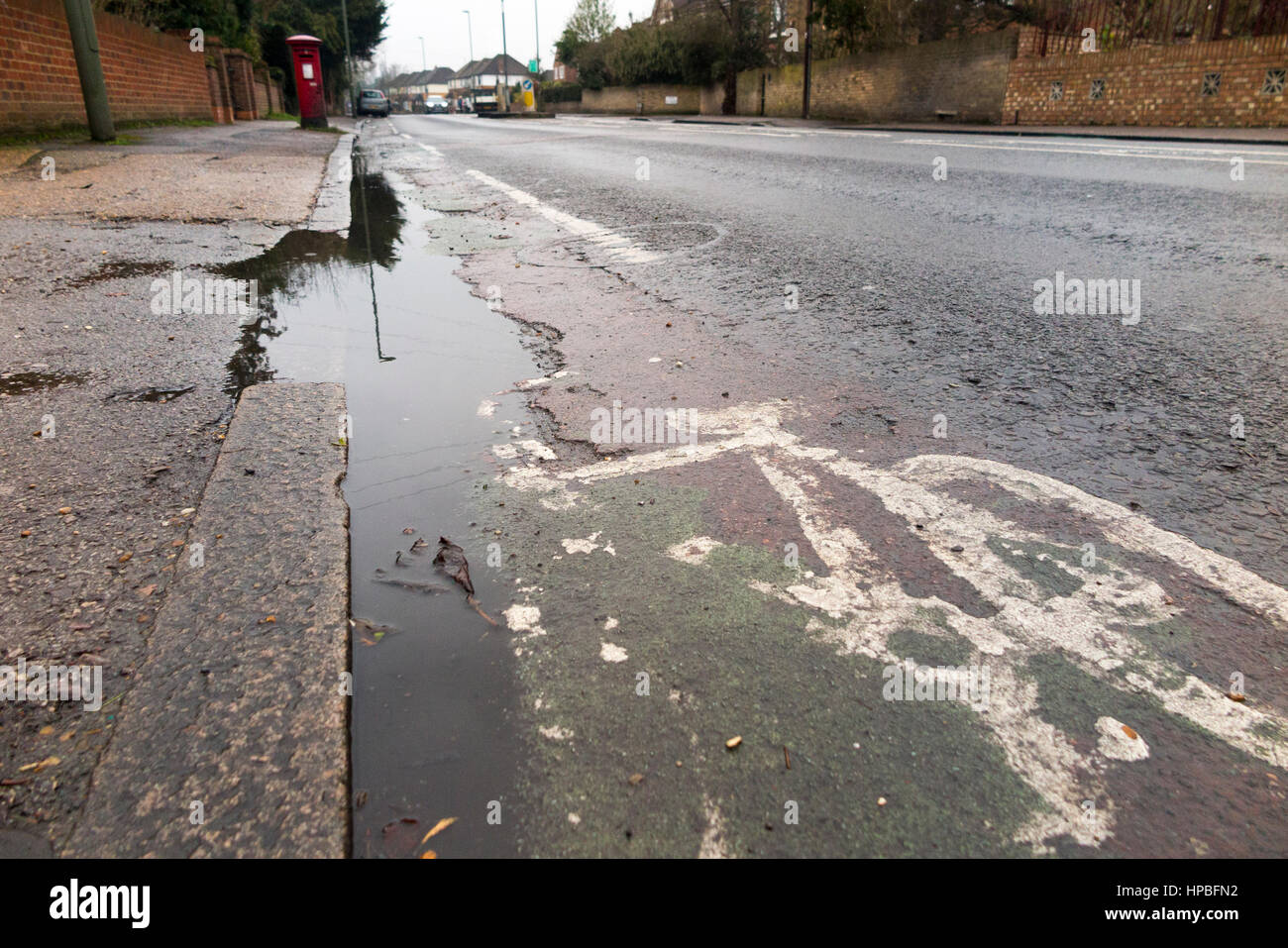 Poor quality broken bicycle / bike / cycle lane / lanes with a cracked