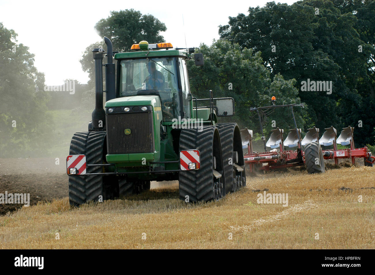 John Deere 9520 high horse powered tractor ploughing stubble in with a