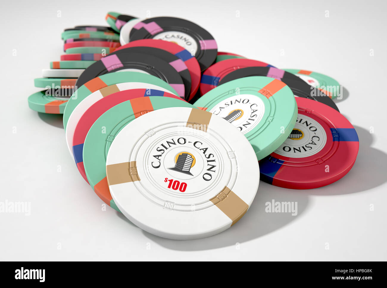 A fallen stack of various values of casino chips on an isolated white