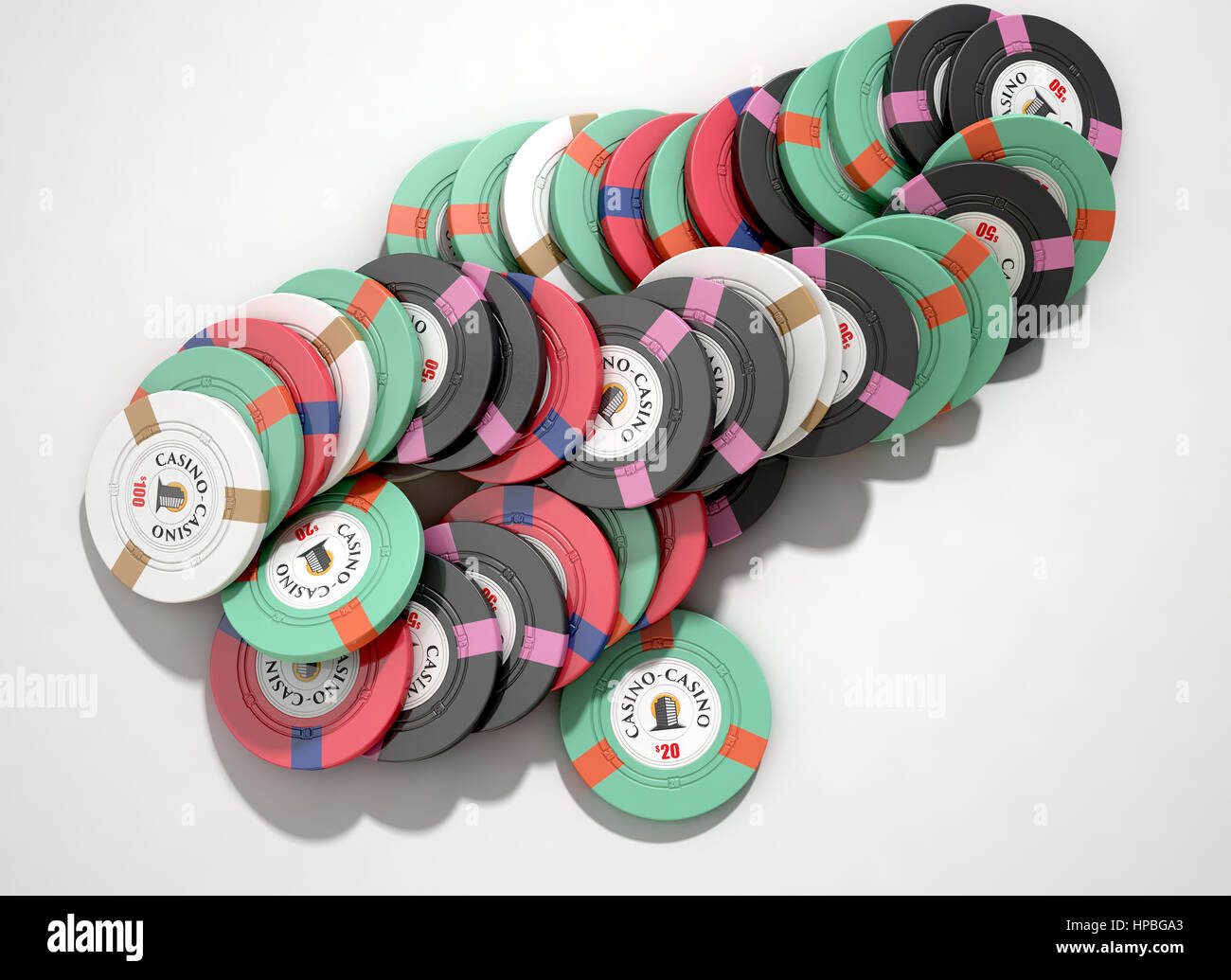 A fallen stack of various values of casino chips on an isolated white
