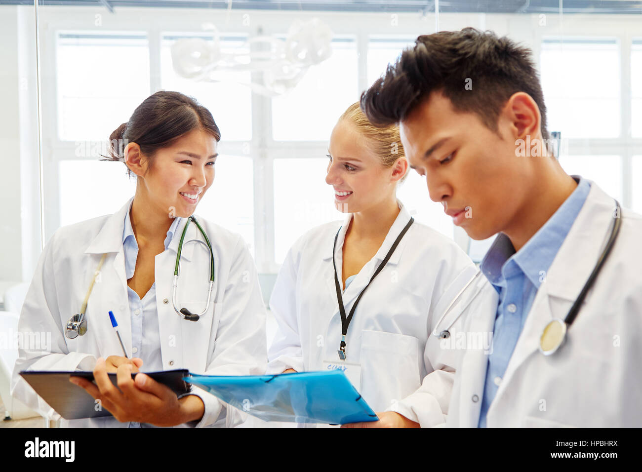 Medical school students in apprenticeship learning together in workshop Stock Photo