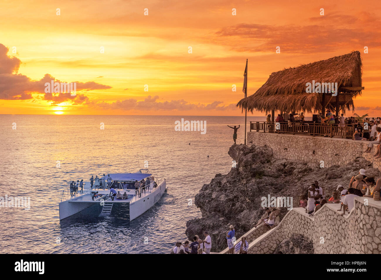 Ricks Cafe open air bar , Rick´s viewpoint at sunset, Catamaran, nightlife, Negril Jamaica, Stock Photo