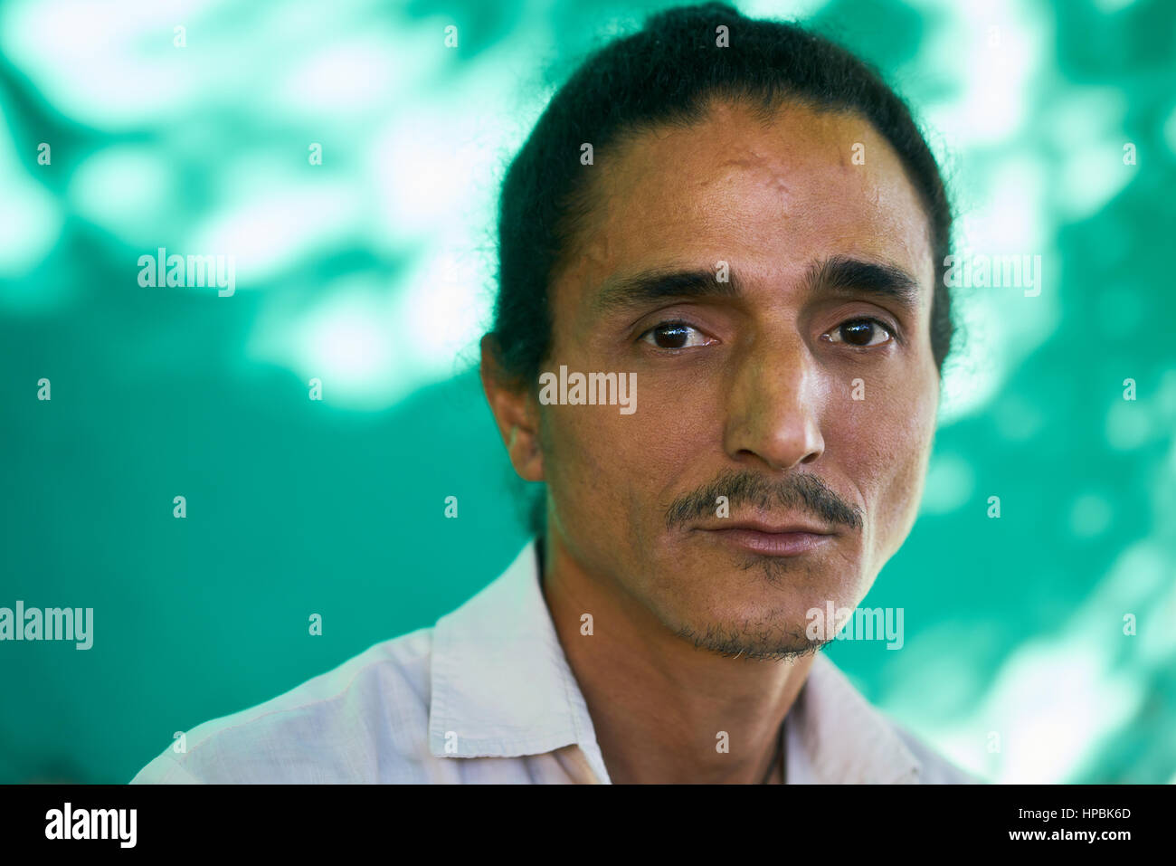 Real Cuban people and emotions, portrait of sad latino man from Havana, Cuba looking at camera with worried face and depressed expression Stock Photo