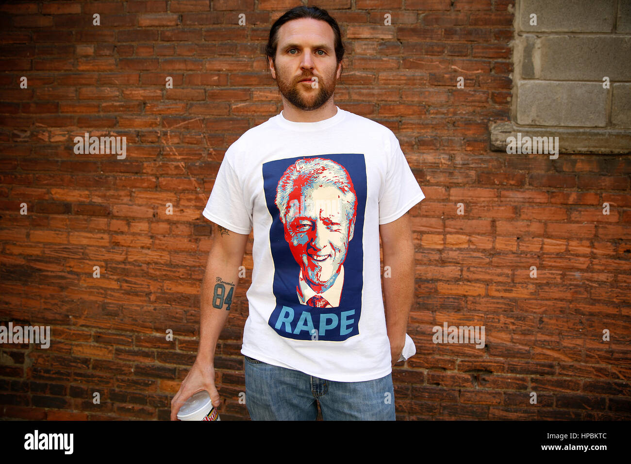A Donald Trump supporter wearing an anti-Clinton shirt poses for a portrait outside of the Republican National Convention on July 21, 2016. Cleveland, Stock Photo