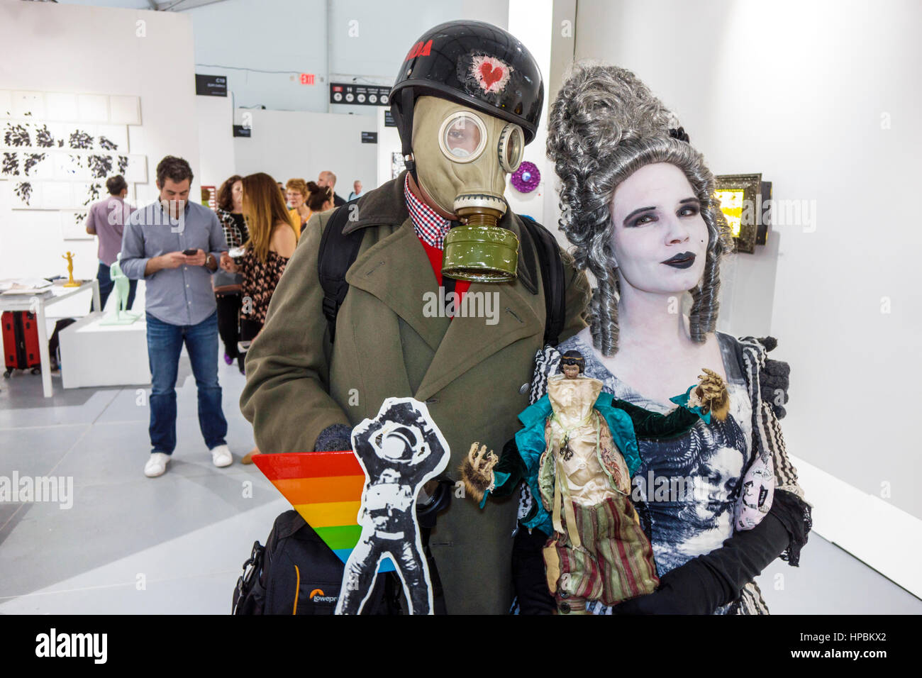 Miami Beach Florida,Art Basel Week,satellite art fair,Scope Art,contemporary art,performance art,man men male,woman female women,costume,gas mask,doll Stock Photo