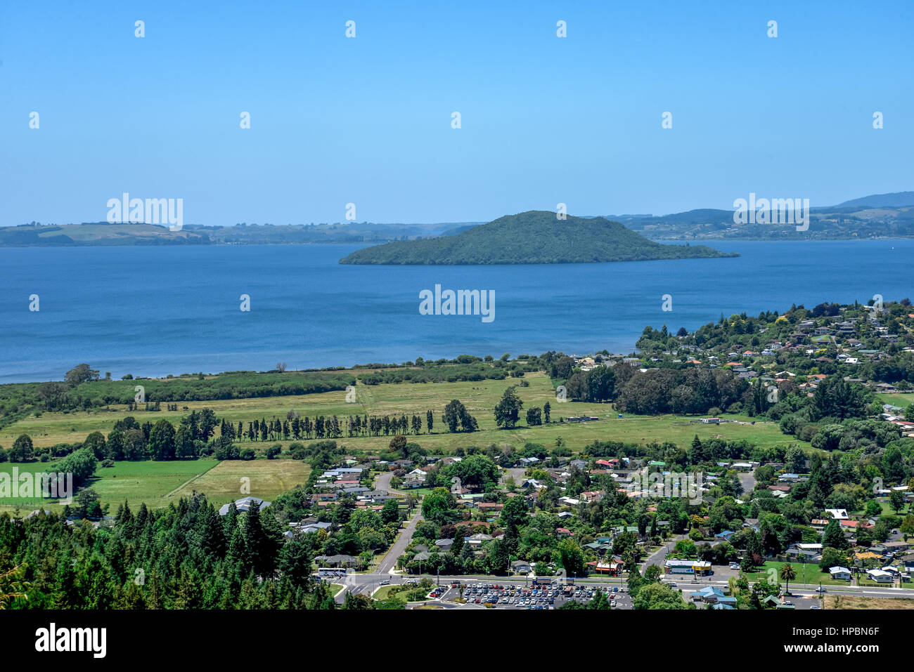 A view of Lake Rotorua with island and a city, New Zealand, North Island Stock Photo