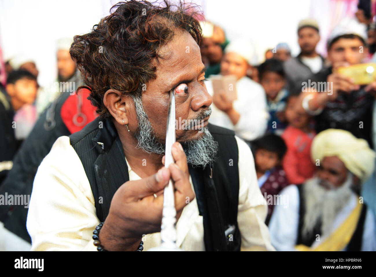 Sufi self-mortification practices at the annual 'Urs (death anniversary) of the Sufi saint Zinda Shah in Makanpur, Uttar Pradesh, India. Stock Photo