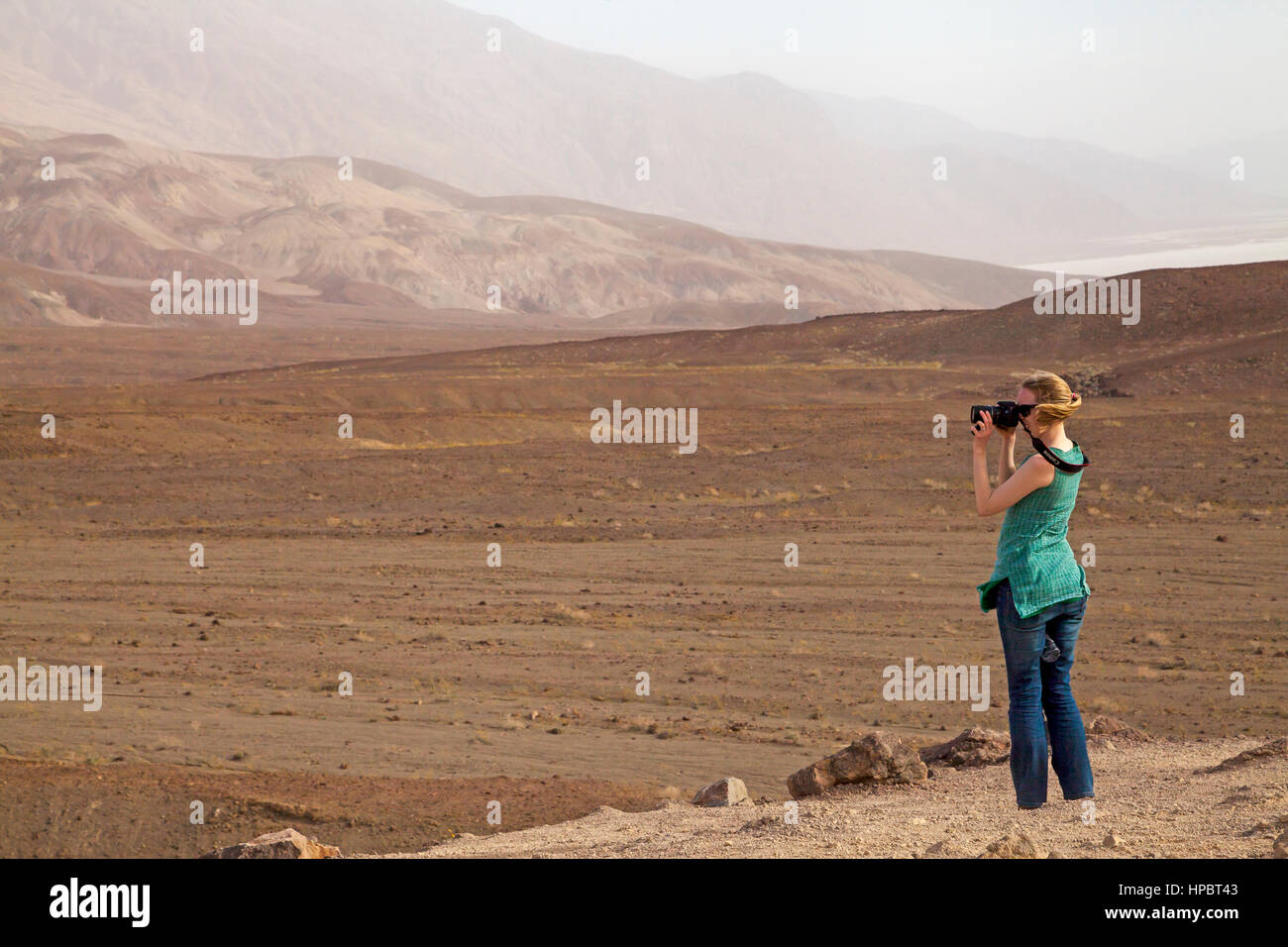 Woman taking photos  in Death Valley, California, USA Stock Photo