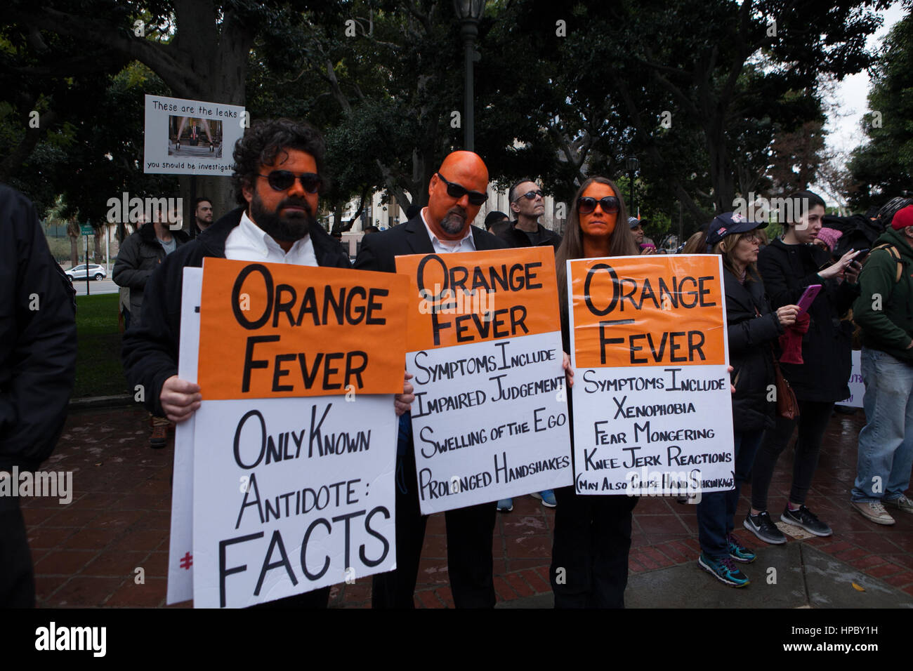 Los Angeles, USA. 20 February, 2017. Protestors with faces painted orange with signs that list the symptoms of 'Orange Fever' gather at Los Angeles city hall for ‘Not Presidents Day’ rally. Zack Clark/Alamay Live News Stock Photo