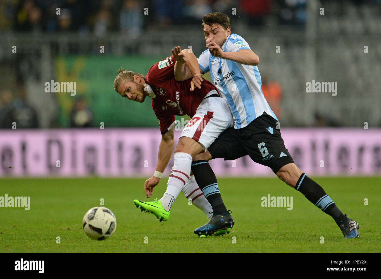 Munich's Sebastian Boenisch (r) and Nuremberg's Rurik Gislason in action during the 2nd Bundesliga soccer match between TSV 1860 Munich and 1. FC Nuremberg at the Allianz Arena in Munich, Germany, 20 February 2017.    (EMBARGO CONDITIONS - ATTENTION: Due to the accreditation guidlines, the DFL only permits the publication and utilisation of up to 15 pictures per match on the internet and in online media during the match.) Photo: Andreas Gebert/dpa Stock Photo