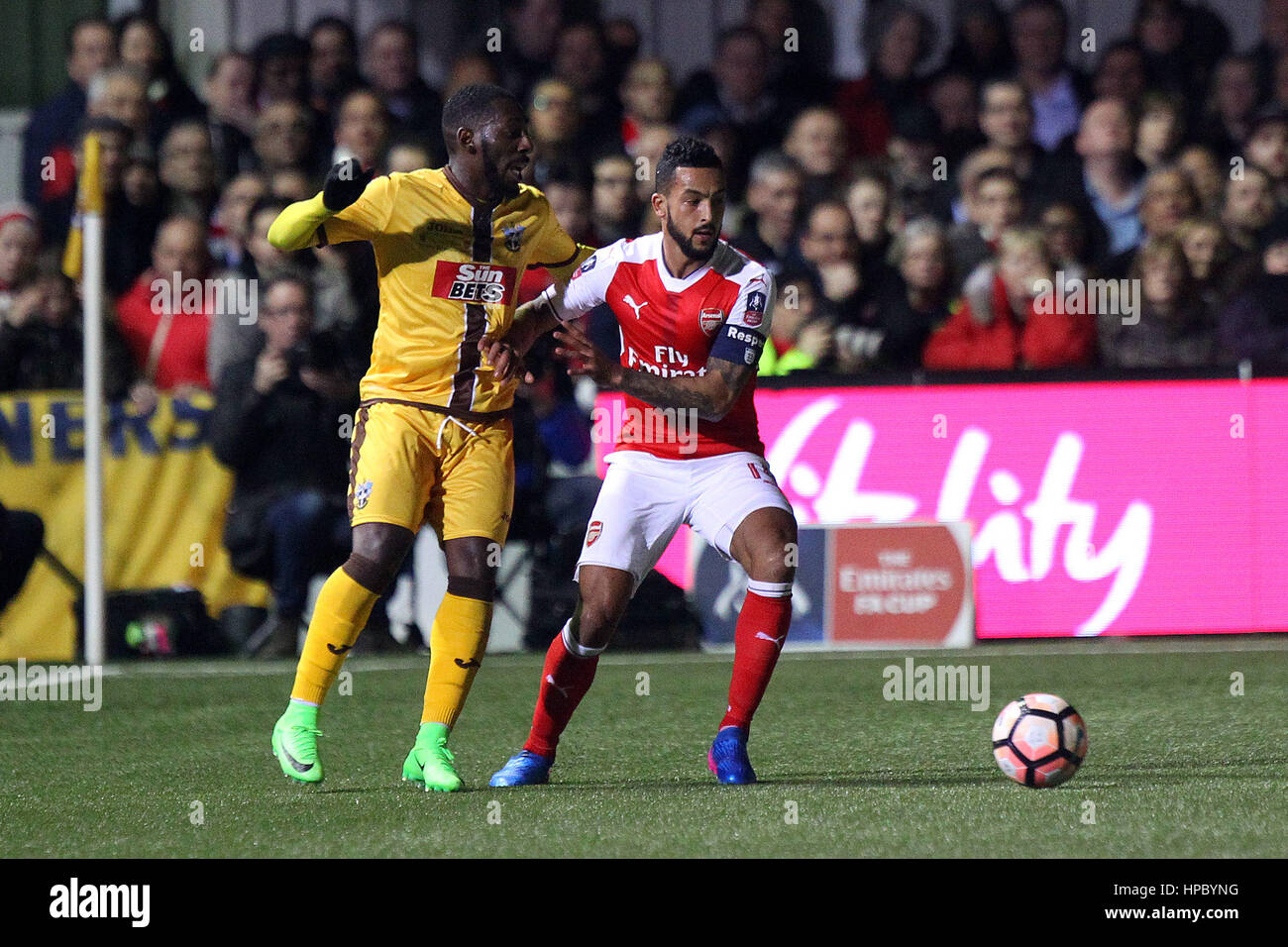 Sutton, UK. 20th Feb, 2017. Theo Walcott of Arsenal and Roarie Deacon of Sutton United in action during the FA Cup Fifth Round match between Sutton United and Arsenal at Borough Sports Ground on February 20th 2017 in Sutton, England. Credit: Daniel Chesterton/Alamy Live News Stock Photo
