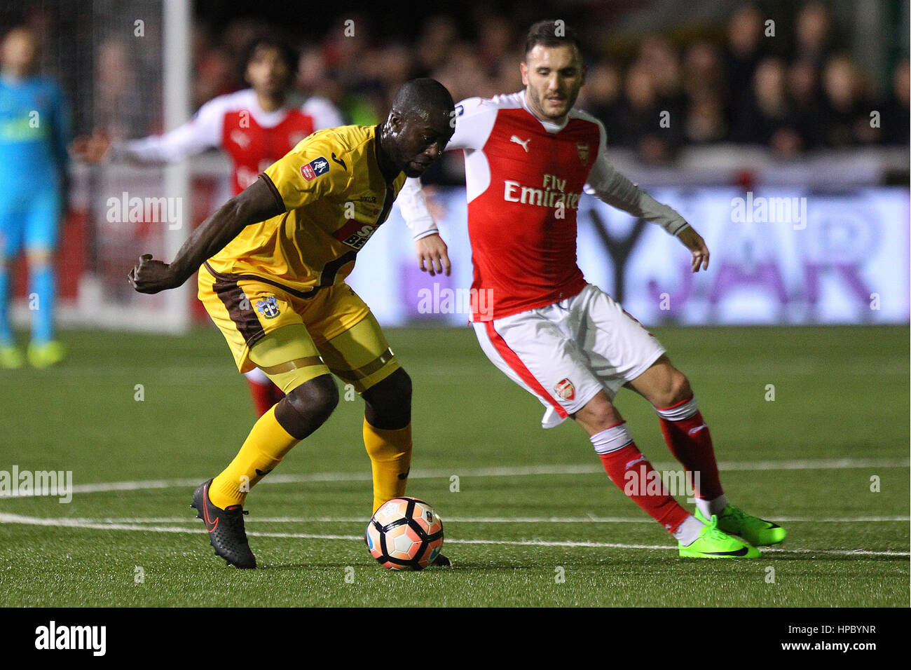 Sutton, UK. 20th Feb, 2017. Roarie Deacon of Sutton United and Lucas of Arsenal in action during the FA Cup Fifth Round match between Sutton United and Arsenal at Borough Sports Ground on February 20th 2017 in Sutton, England. Credit: Daniel Chesterton/Alamy Live News Stock Photo