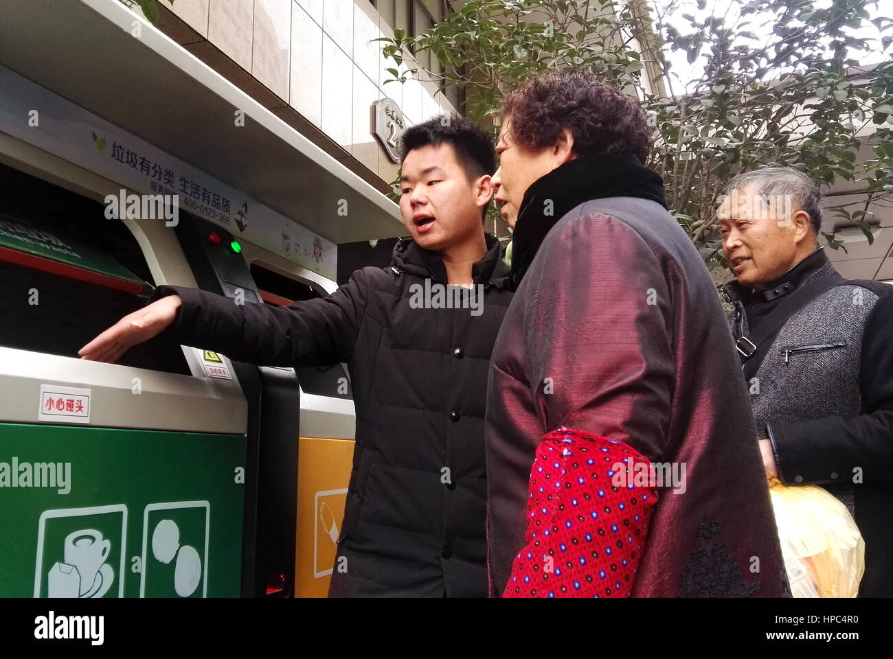 Hefei, Hefei, China. 21st Feb, 2017. Hefei, CHINA-February 21 2017: (EDITORIAL USE ONLY. CHINA OUT) .A resident uses the intelligent system for rubbish classification at a community district in Hefei, east China's Anhui Province, February 21st, 2017. Residents can get free disposable bags at the system and scan the 2-dimensional bar code to put rubbish in different rubbish bins. Credit: SIPA Asia/ZUMA Wire/Alamy Live News Stock Photo